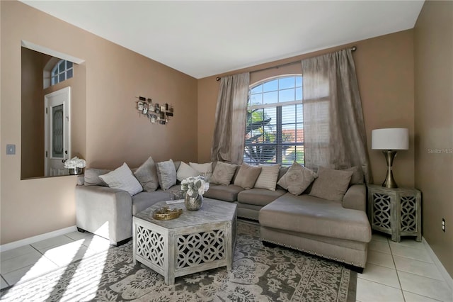 living room featuring baseboards and light tile patterned floors