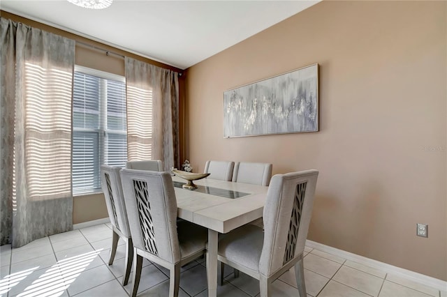 dining area with light tile patterned floors and baseboards