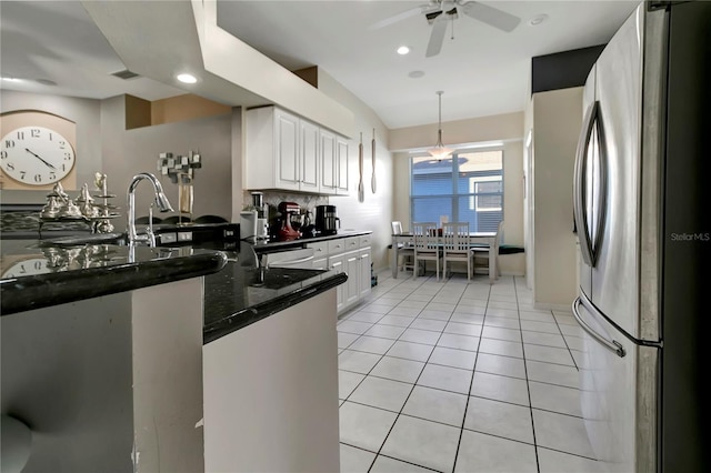 kitchen with recessed lighting, decorative backsplash, freestanding refrigerator, white cabinets, and light tile patterned flooring