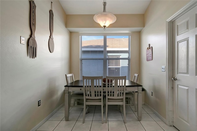 dining space with baseboards and light tile patterned floors