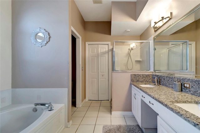 full bathroom with double vanity, a stall shower, tile patterned floors, a sink, and a bath