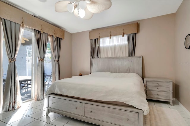 bedroom featuring access to outside, ceiling fan, and light tile patterned floors