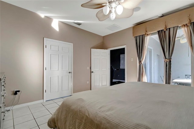 bedroom featuring ceiling fan, baseboards, and light tile patterned floors