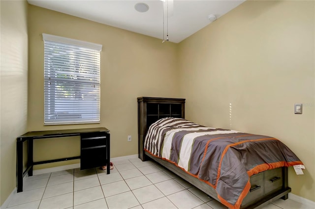 bedroom featuring light tile patterned floors and baseboards