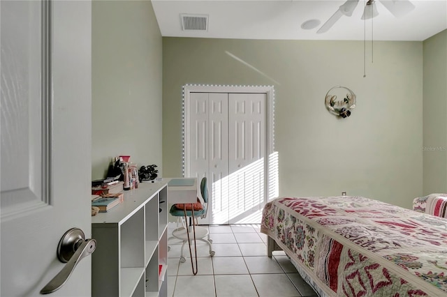 bedroom with light tile patterned floors, ceiling fan, visible vents, and a closet