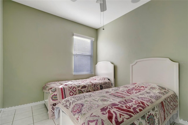 bedroom featuring light tile patterned flooring, ceiling fan, and baseboards