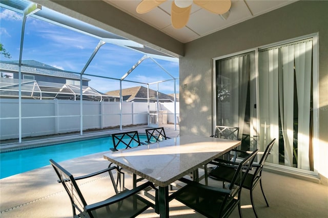 view of swimming pool with a fenced in pool, a patio, ceiling fan, a lanai, and outdoor dining space