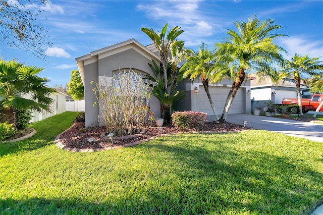 view of front facade featuring driveway, a front lawn, and stucco siding