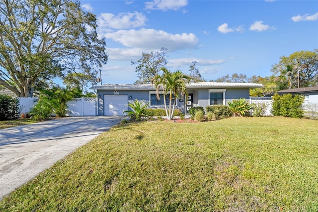 single story home featuring driveway, a front lawn, an attached garage, and fence