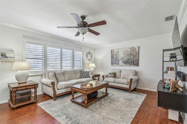 living room featuring visible vents, ornamental molding, a ceiling fan, and wood finished floors