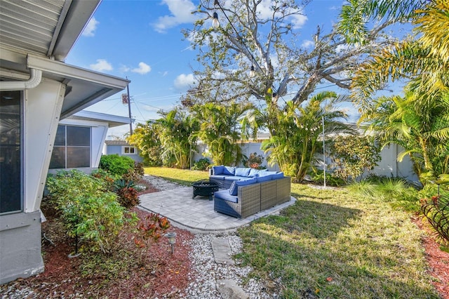 view of yard with an outdoor living space with a fire pit, a patio, and fence