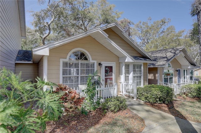 view of front of property featuring roof with shingles