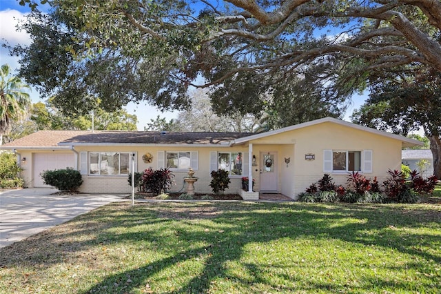 single story home with a garage, a front yard, concrete driveway, and brick siding