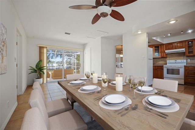 dining area featuring light tile patterned floors, attic access, visible vents, and baseboards