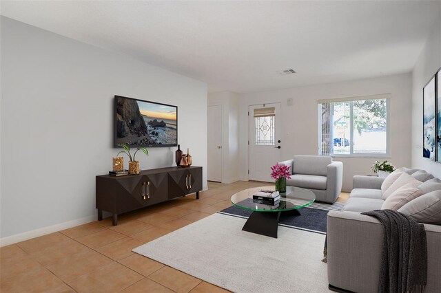 1549 San Christopher Dr, Dunedin, FL 34698 - living area featuring light tile patterned floors, visible vents, and baseboards