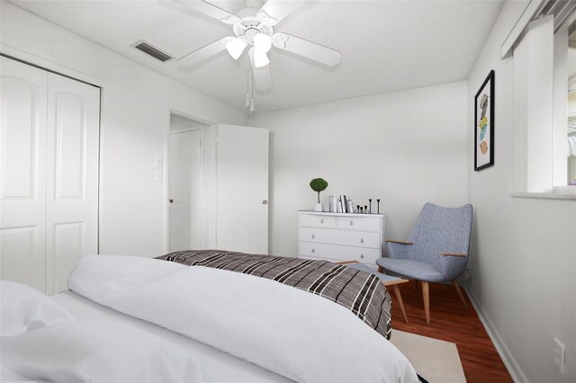 1549 San Christopher Dr, Dunedin, FL 34698 - bedroom with a closet, visible vents, a ceiling fan, wood finished floors, and baseboards