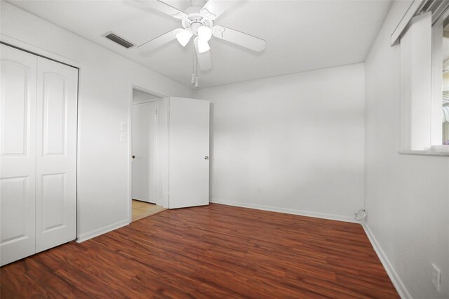 1549 San Christopher Dr, Dunedin, FL 34698 - unfurnished bedroom with wood finished floors, a ceiling fan, visible vents, baseboards, and a closet