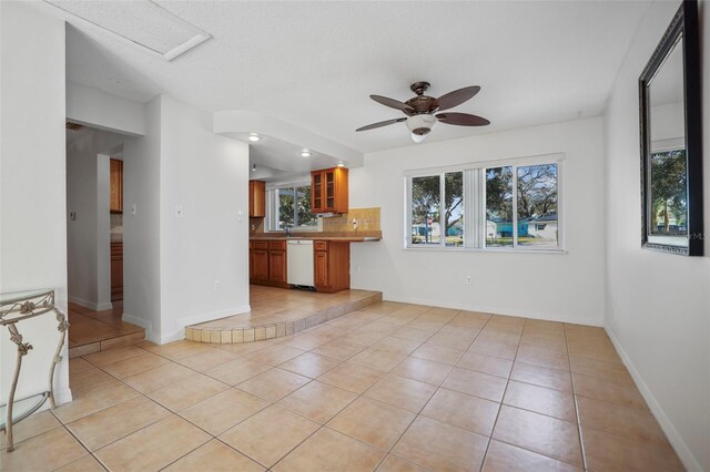 1549 San Christopher Dr, Dunedin, FL 34698 - interior space featuring light tile patterned floors, a sink, a ceiling fan, and baseboards
