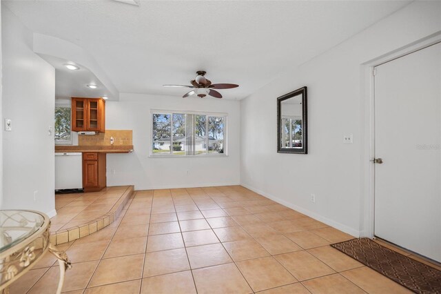 1549 San Christopher Dr, Dunedin, FL 34698 - unfurnished living room with light tile patterned floors, baseboards, and a ceiling fan