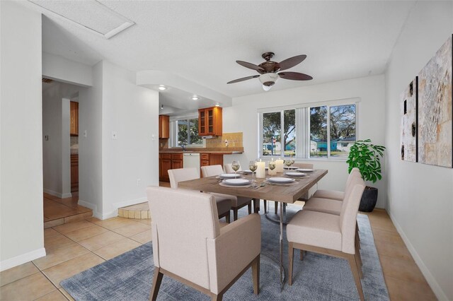 1549 San Christopher Dr, Dunedin, FL 34698 - dining room with ceiling fan, light tile patterned flooring, and baseboards