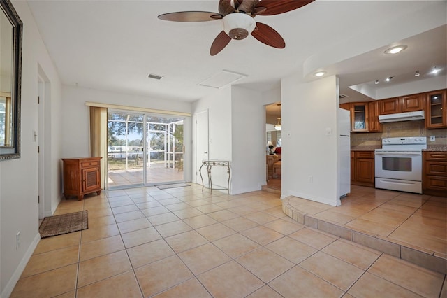 1549 San Christopher Dr, Dunedin, FL 34698 - unfurnished living room with light tile patterned floors, visible vents, attic access, ceiling fan, and baseboards