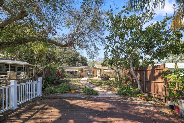 1549 San Christopher Dr, Dunedin, FL 34698 - view of front of home with a sunroom, a fenced backyard, and a deck