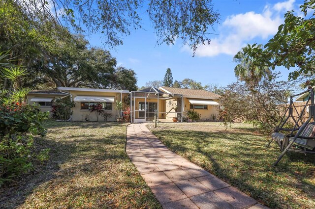 1549 San Christopher Dr, Dunedin, FL 34698 - view of front of home with a front yard and stucco siding