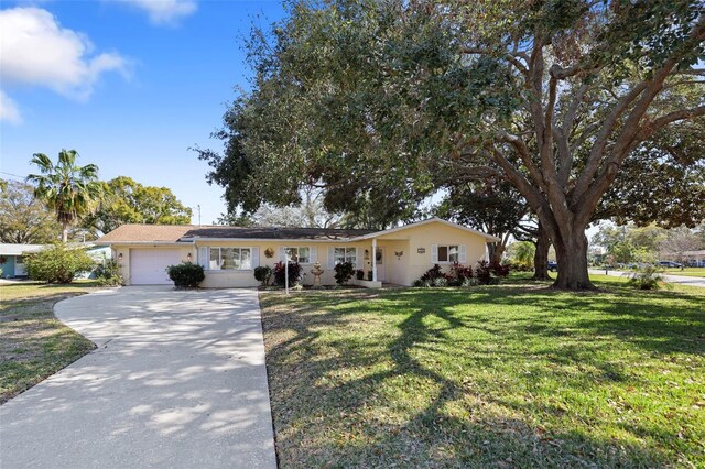 1549 San Christopher Dr, Dunedin, FL 34698 - single story home featuring driveway, an attached garage, and a front lawn
