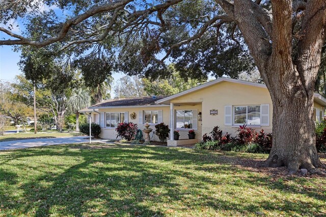 1549 San Christopher Dr, Dunedin, FL 34698 - single story home with stucco siding, a front lawn, and brick siding