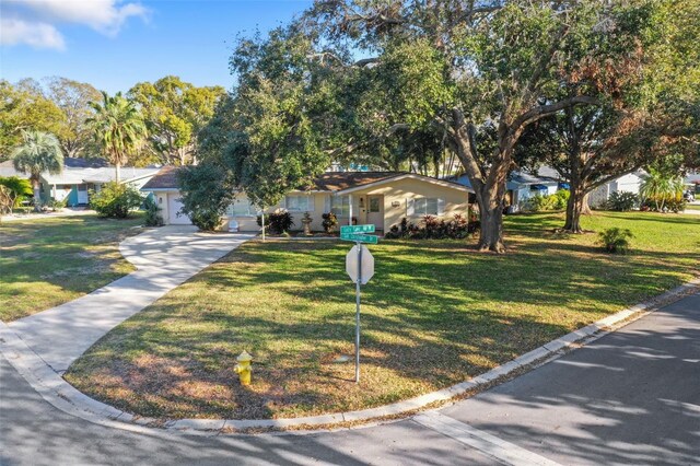1549 San Christopher Dr, Dunedin, FL 34698 - ranch-style home with a garage, a front yard, and concrete driveway