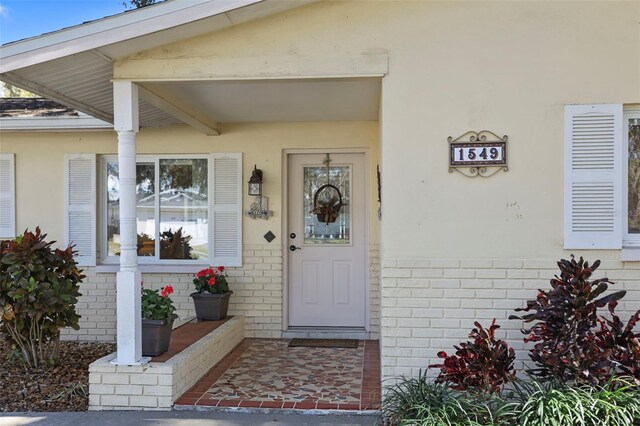 1549 San Christopher Dr, Dunedin, FL 34698 - view of exterior entry with brick siding