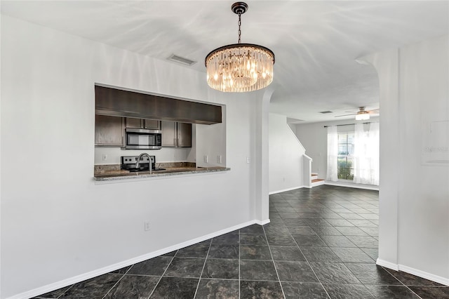 kitchen with stainless steel appliances, pendant lighting, visible vents, and baseboards