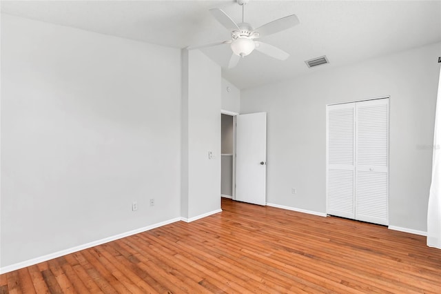 unfurnished bedroom featuring baseboards, visible vents, ceiling fan, light wood-type flooring, and a closet