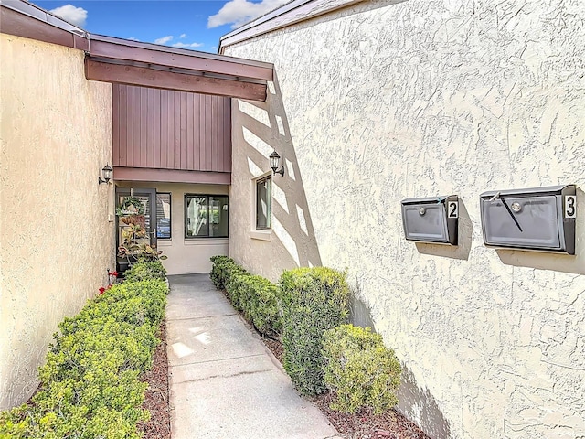 doorway to property with stucco siding