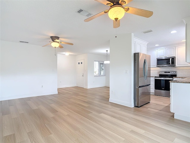 kitchen with white cabinetry, tasteful backsplash, visible vents, and stainless steel appliances