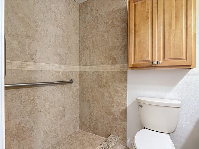 full bathroom featuring toilet and a tile shower