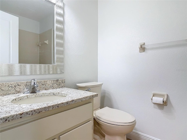 full bath with a shower, vanity, and toilet