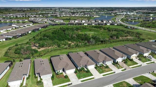 birds eye view of property with a residential view and a water view