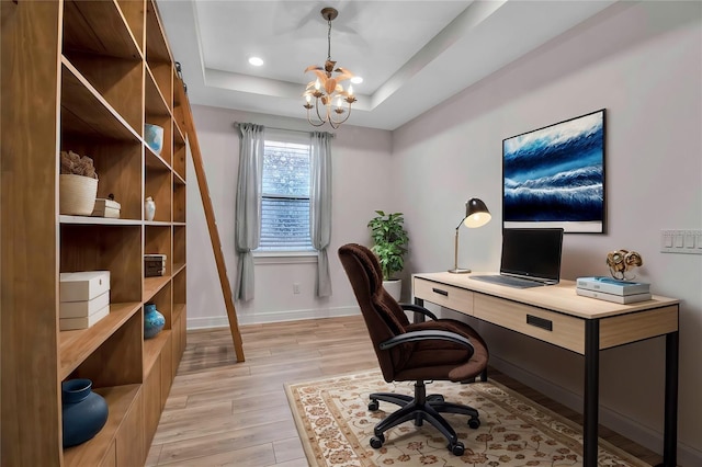 home office with baseboards, a raised ceiling, light wood-style floors, a chandelier, and recessed lighting