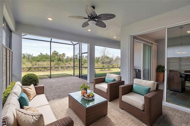 sunroom featuring a ceiling fan