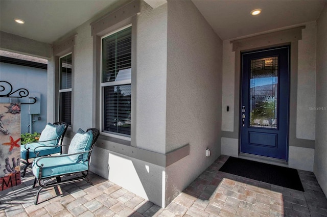 entrance to property featuring stucco siding