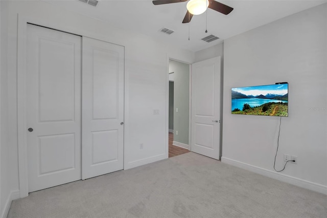 unfurnished bedroom featuring baseboards, visible vents, and carpet flooring