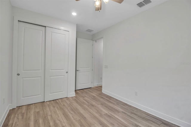 unfurnished bedroom featuring ceiling fan, light wood-style flooring, visible vents, baseboards, and a closet