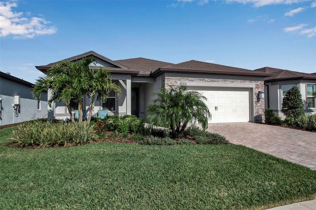 view of front facade with a garage, roof with shingles, decorative driveway, a front lawn, and stucco siding