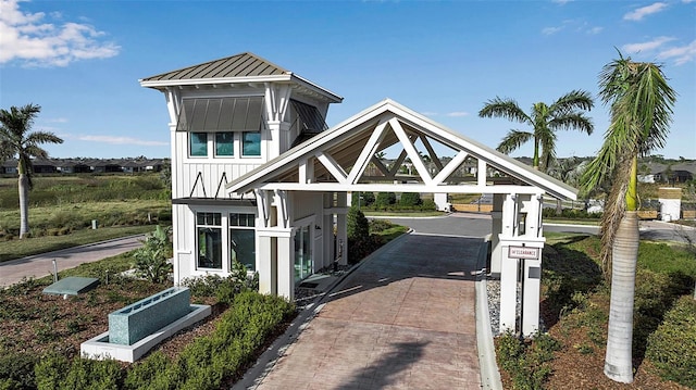 view of front facade with a standing seam roof, metal roof, and board and batten siding