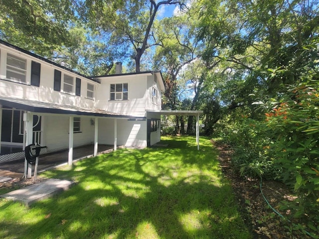 view of home's exterior with a yard and a chimney