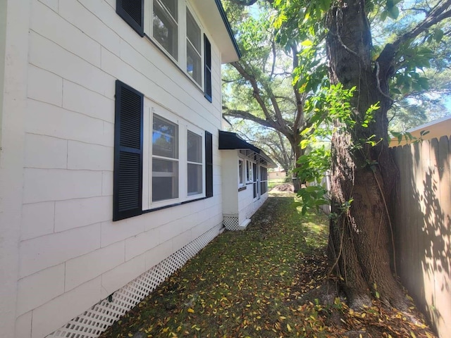 view of home's exterior featuring fence