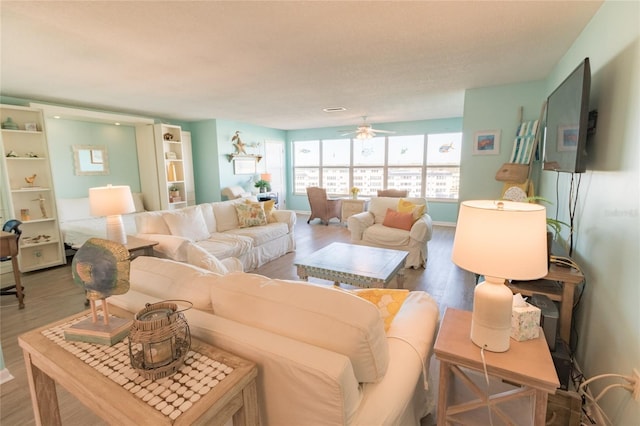 living room featuring ceiling fan and wood finished floors