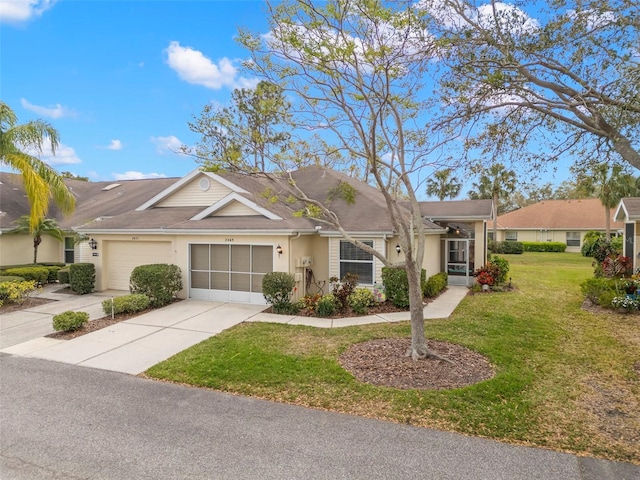 single story home with a garage, a front yard, concrete driveway, and stucco siding