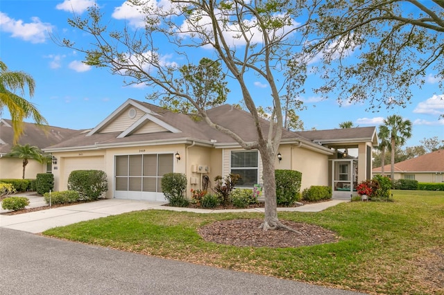 ranch-style home with a front lawn, driveway, an attached garage, and stucco siding